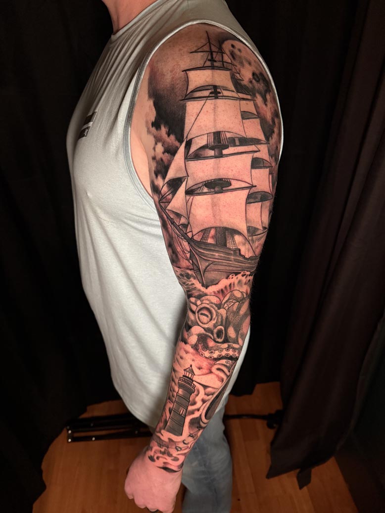 Black ink Pirate Ship arm tattoo