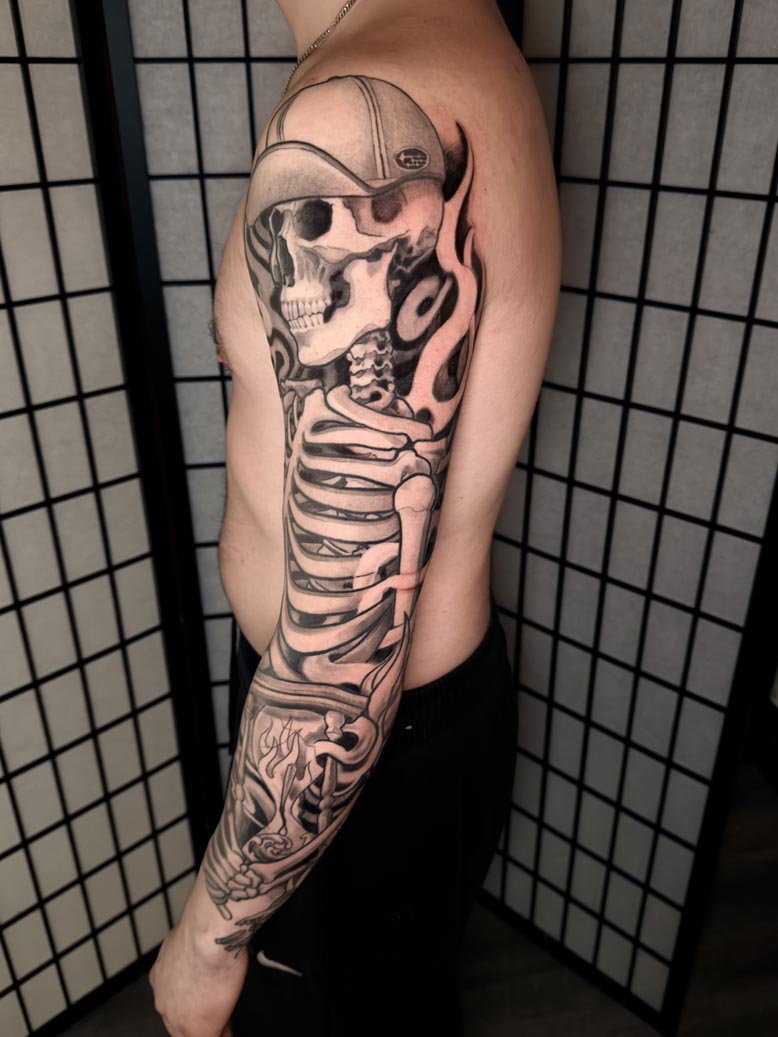 Skull and ribs arm tattoo