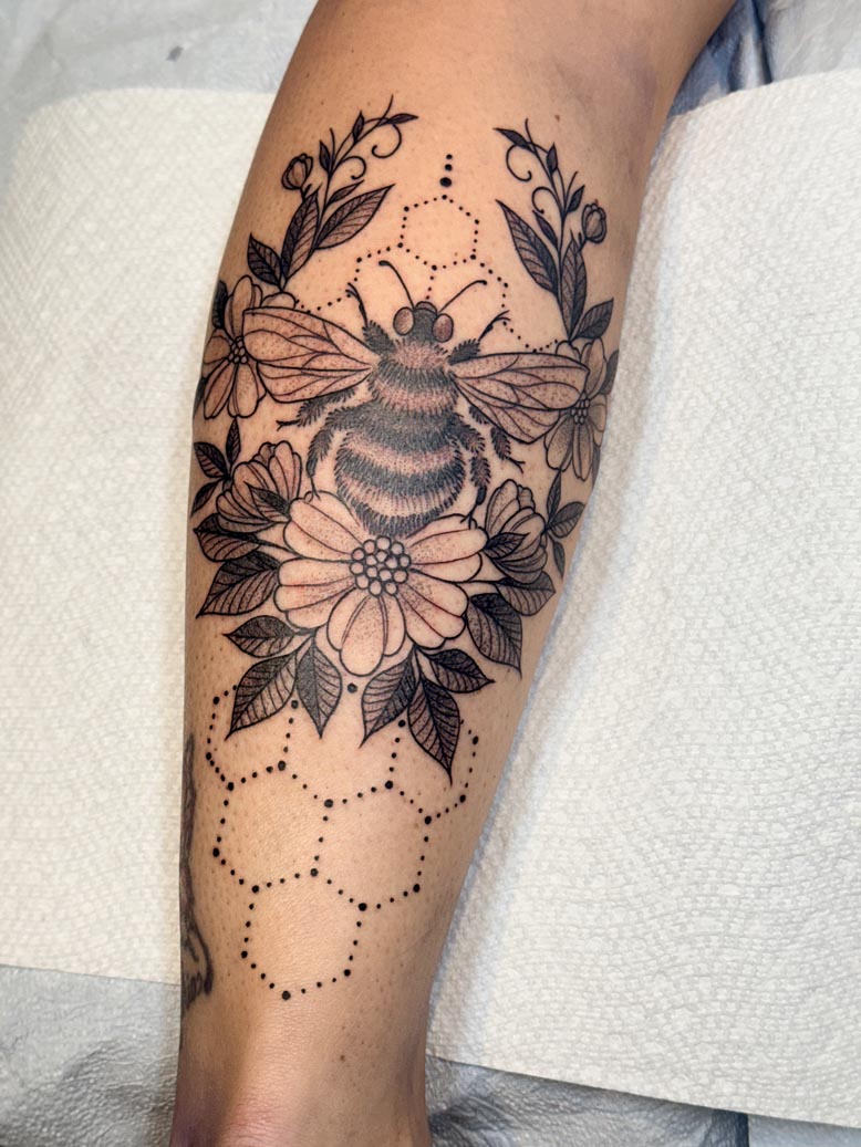 Black ink bee, florals and honeycomb tattoo