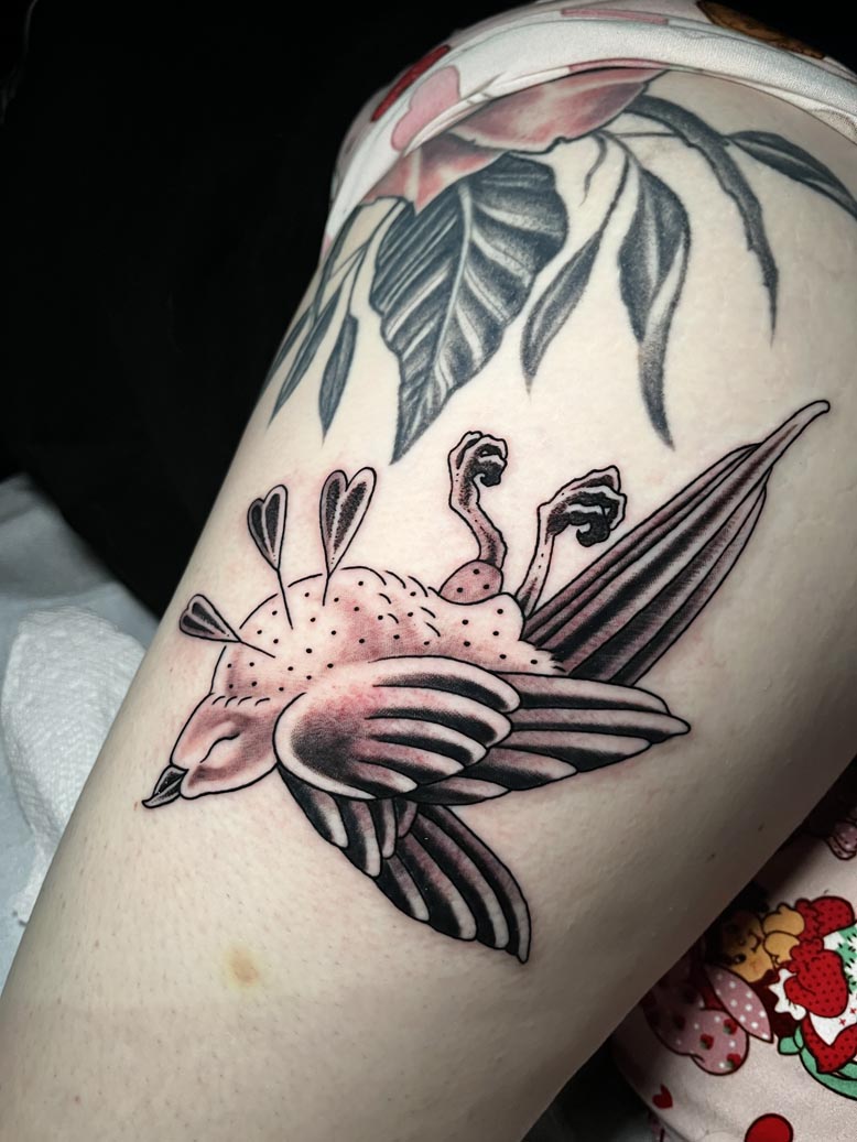 Black ink dead bird tattoo