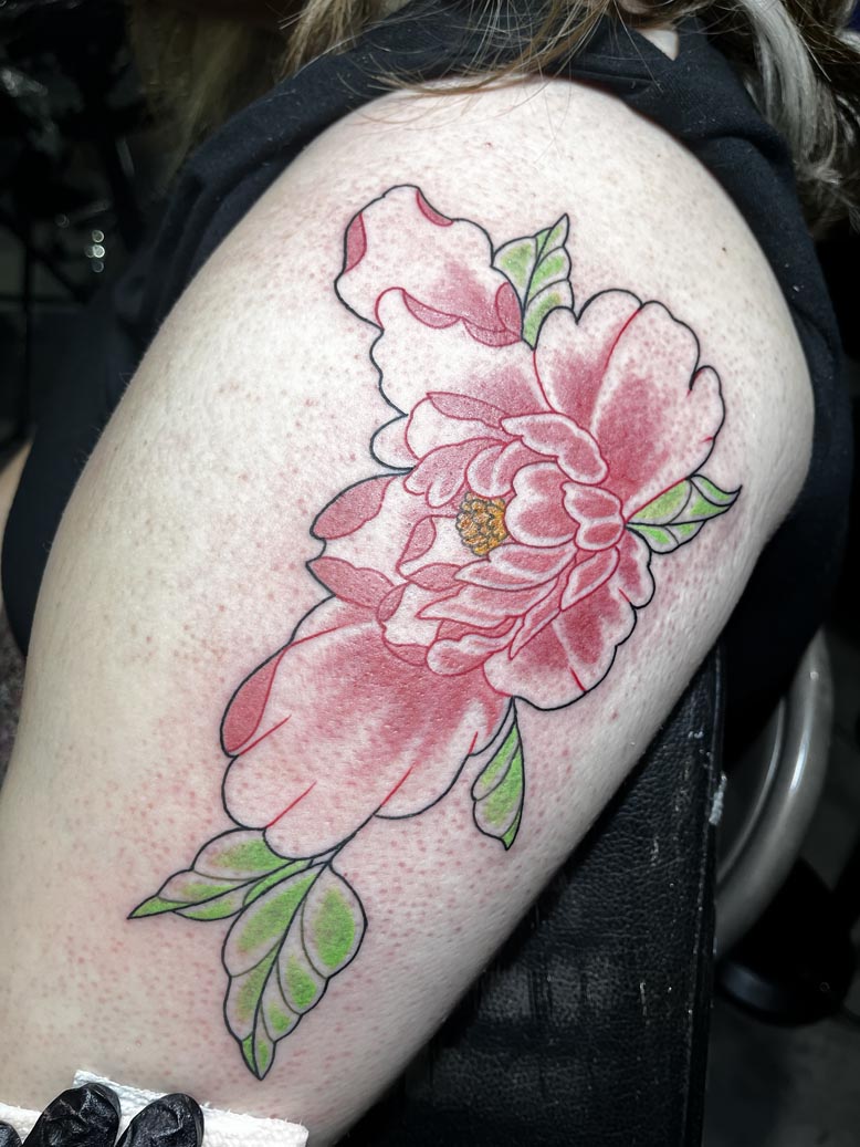 Pink flower thigh tattoo