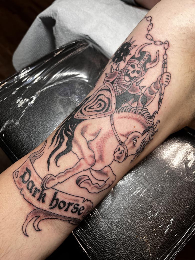 Dark horse black ink tattoo