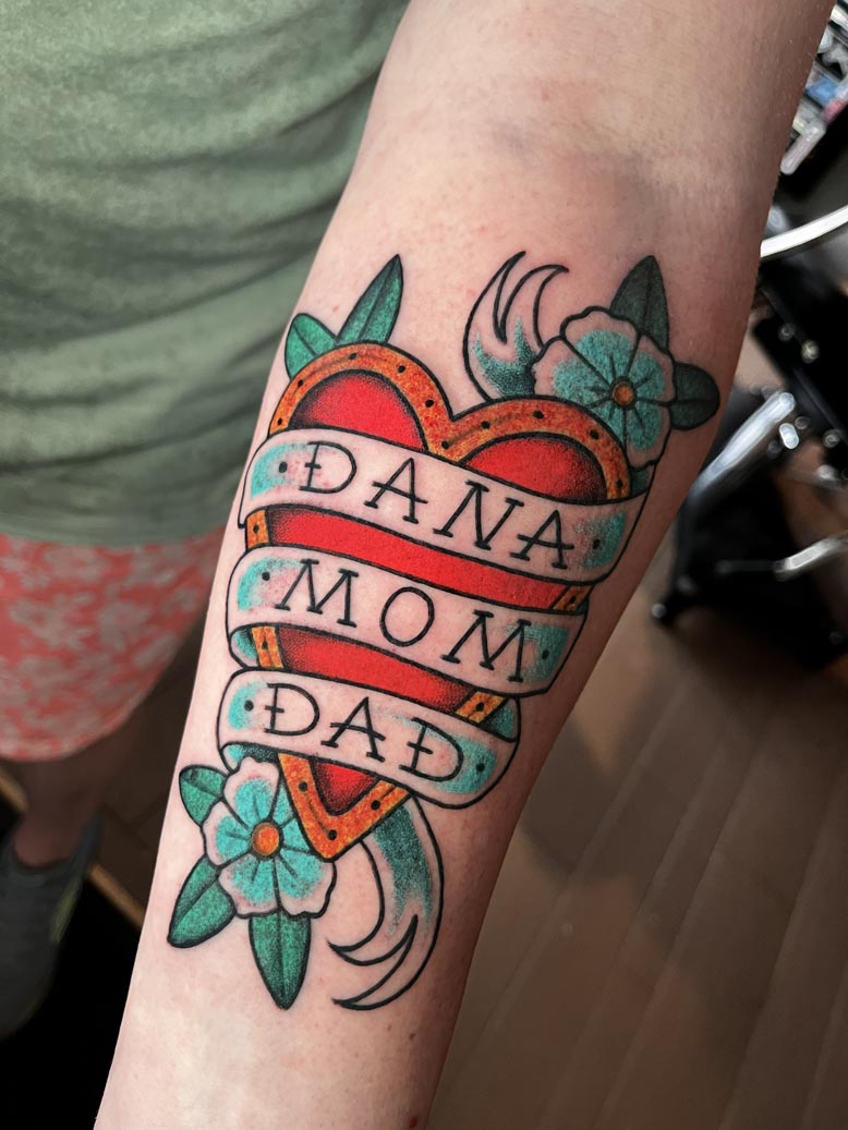 Classic heart tattoo with the words "Dana, Mom, Dad"