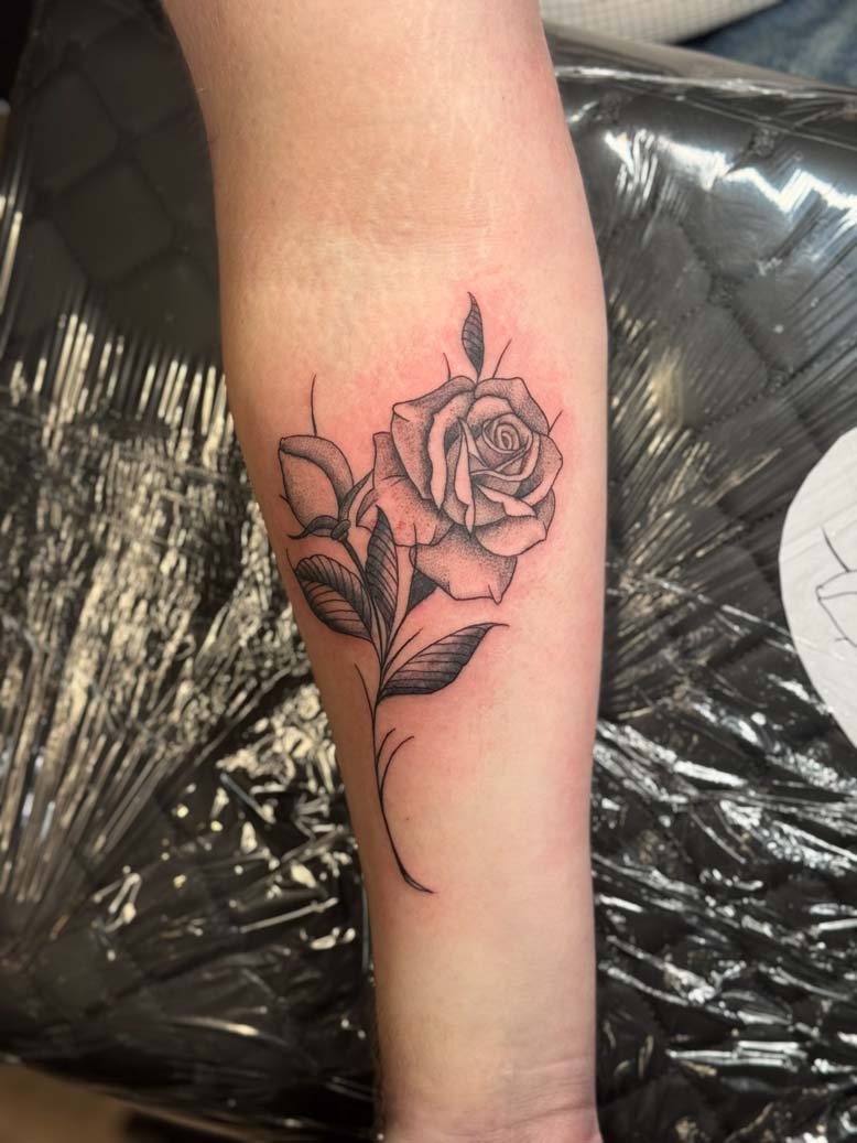 Black in rose tattoo on an arm