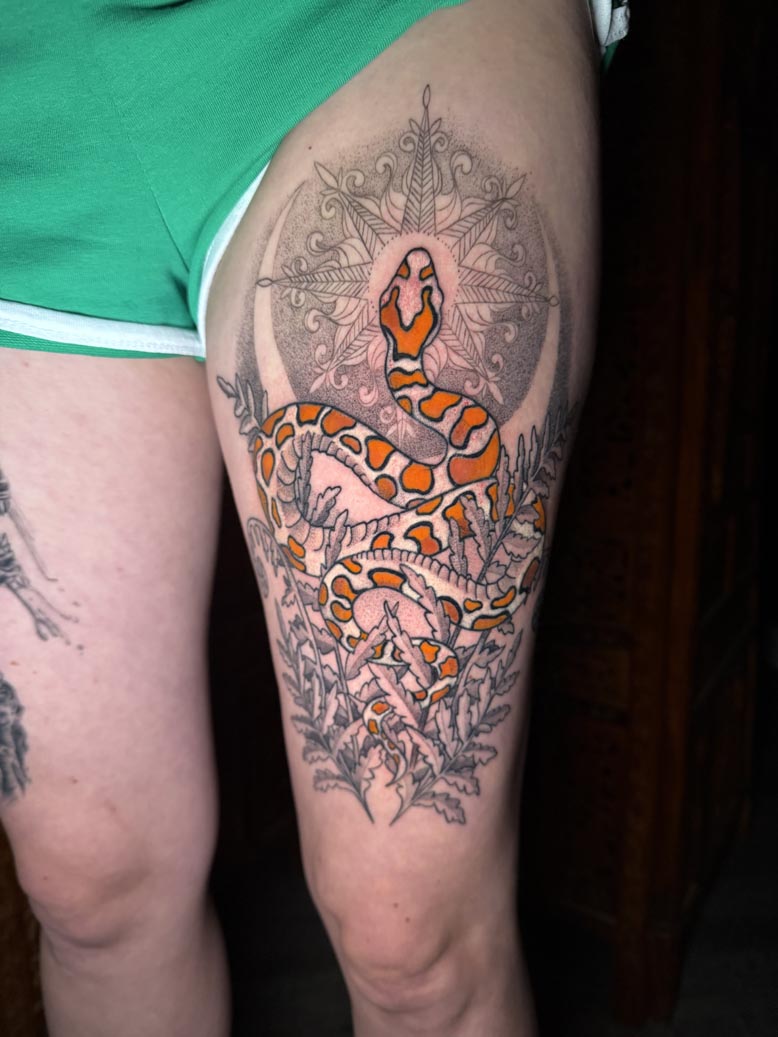 Orange and white snack thigh tatto