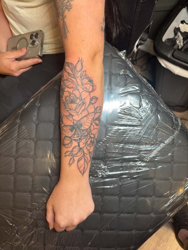 Black ink floral lower arm tatto