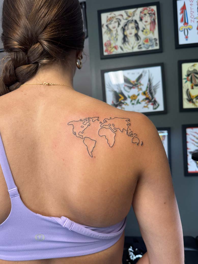 Finished world map tattoo on upper back