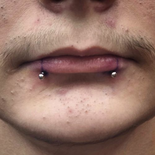Close up of double lip piercings