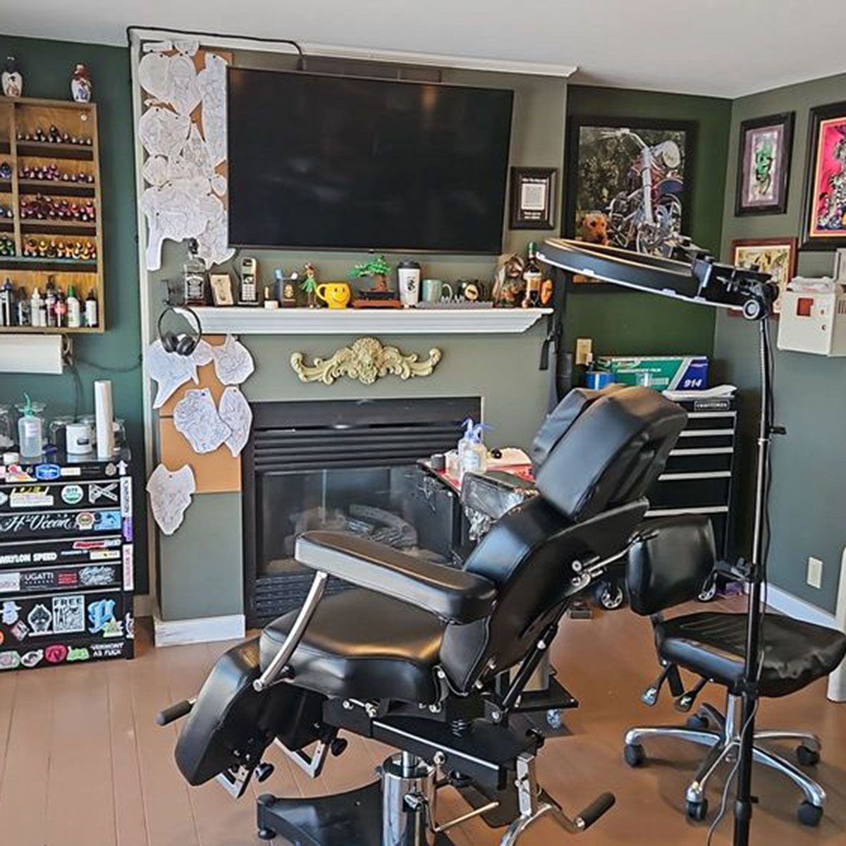 Tattoo chair in front of a fireplace with tv